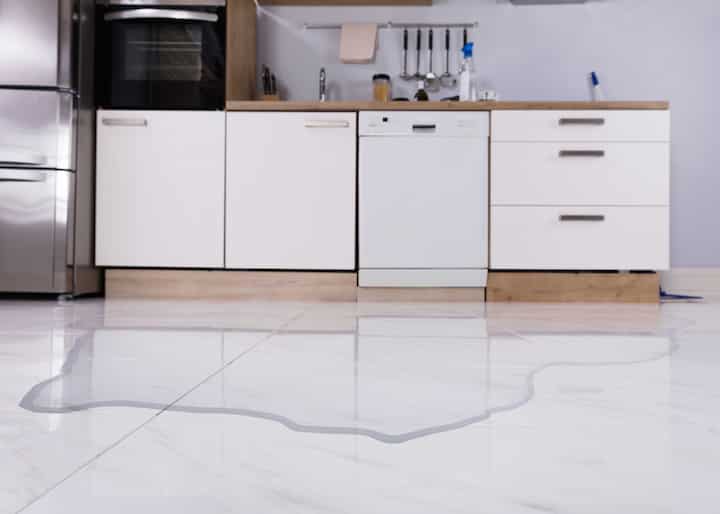 A kitchen floor with water damage and flooding in Augusta, GA